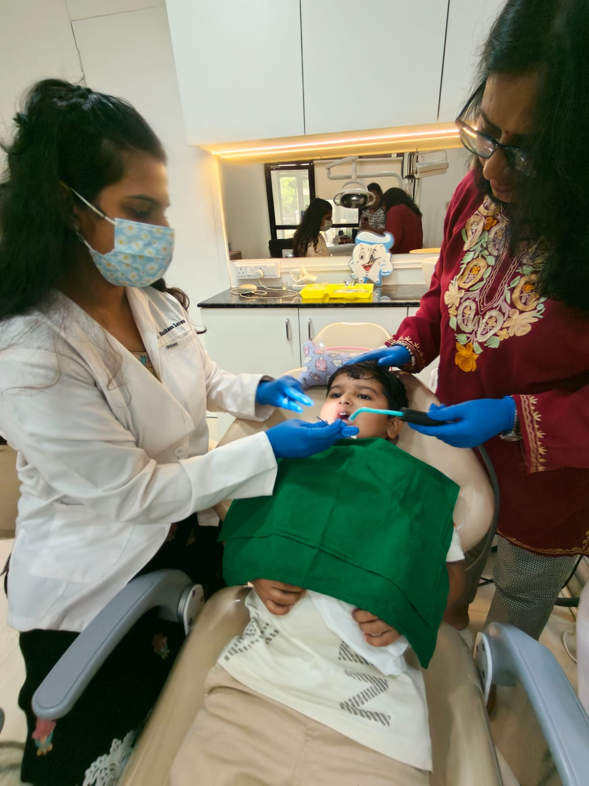 Dr. Muskaan Saxena treating a young patient at Wow Dental Studio Ulwe with parent assisting